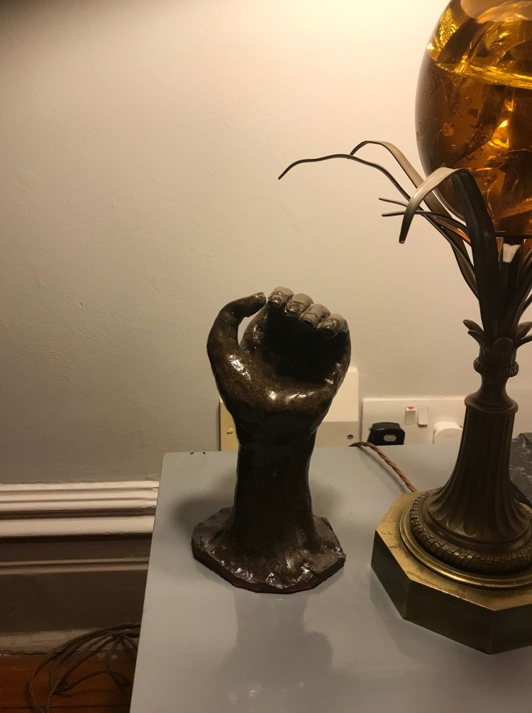 A clay sculpture of a hand by Ciorsdan Glass