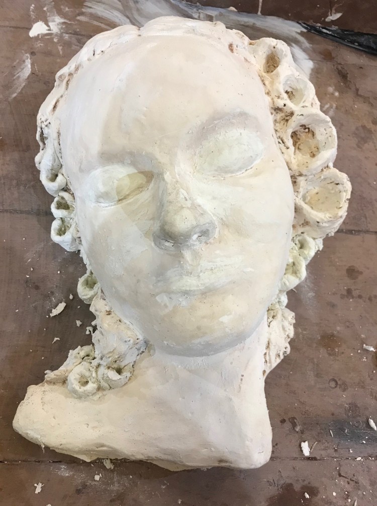 A porcelain sculpture of a sleeping woman by Ciorsdan Glass 