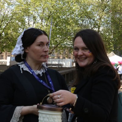 A photograph of Ciorsdan Glass holding a lamp with an actress dressed as Florence Nightingale.