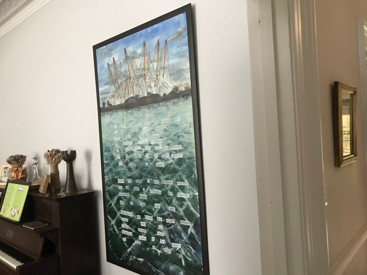 A painting of the Millennium Dome and the Thames by Ciorsdan Glass. There is a poem floating in the river. 